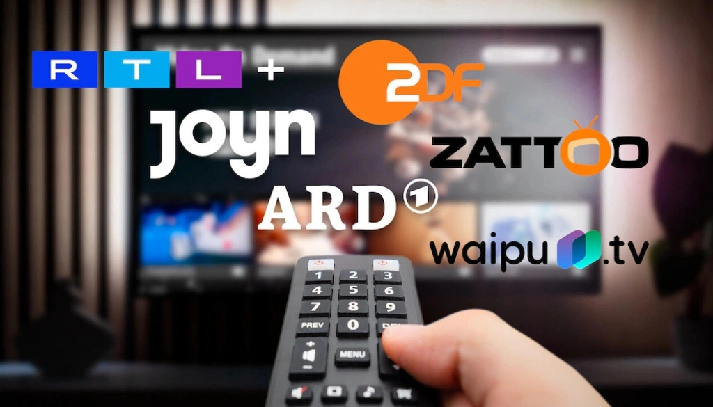 A close-up of a TV remote control pointing at a screen displaying various streaming platforms, including RTL+, ZDF, Joyn, ARD, and Waipu.tv. The screen is showing an interface of live TV options, indicating easy access to multiple channels.